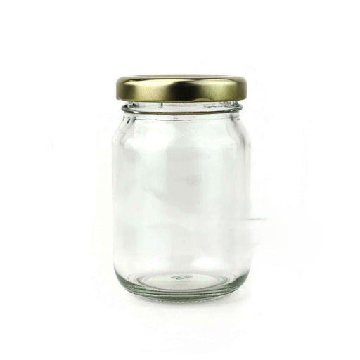 Clear glass jar with a gold lid on a white background