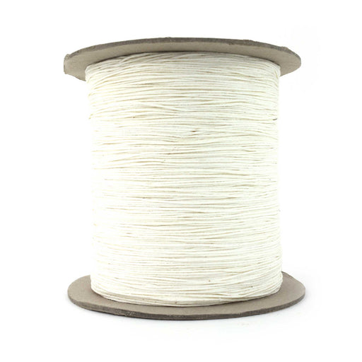 A spool of white bulk wick for candle making.