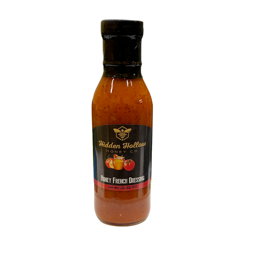 A bottle of Hidden Hollow Honey Co. Honey French Dressing with a black cap and a black label featuring gold lettering and fruit illustrations, set against a plain white background.