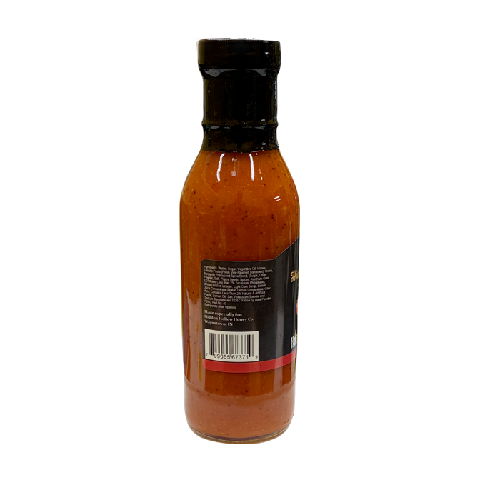 A bottle of red honey french salad dressing with a black cap and a black label showing the ingredients, photographed against a plain white background.