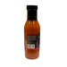 A bottle of red honey french salad dressing with a black cap and a black label showing the ingredients, photographed against a plain white background.