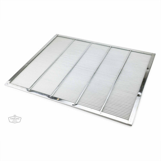 A metal queen excluder with a grid-like pattern used in beekeeping to prevent the queen from entering honey supers.
